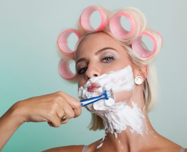 Kvinde med pink curlers barberer sig