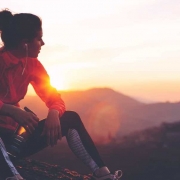 The-Real-CBD-Blog-balsamo-de-cbd-para-deportistas Mujer en la cima de una montaña sentada después de correr