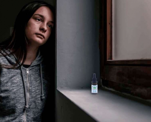 Adolescente mirando tristemente por la ventana