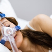 The-Real-CBD-Blog-CBD-para-la-apnea-del-sueno Mujer con aparato para la apnea del sueño en