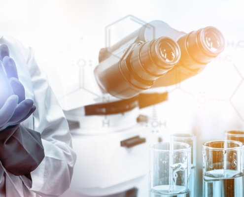 Ayudante de laboratorio con botella y microscopio
