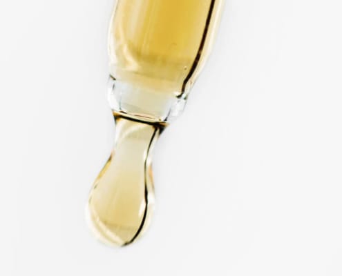Close-up of a pipette with oil
