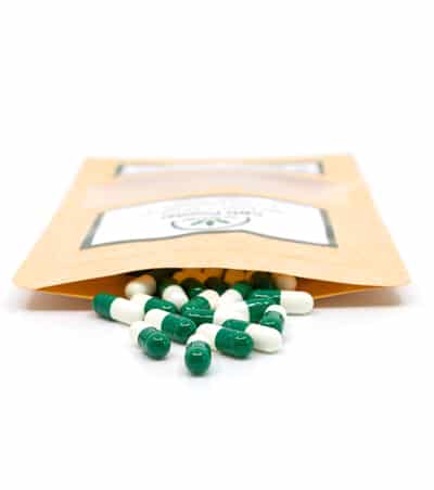 CBD powder green capsules with open pouch - The Real CBD Brand