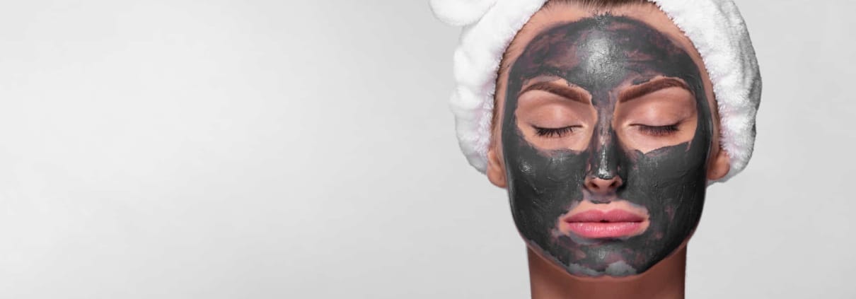 Femme avec masque d'argile pour la peau