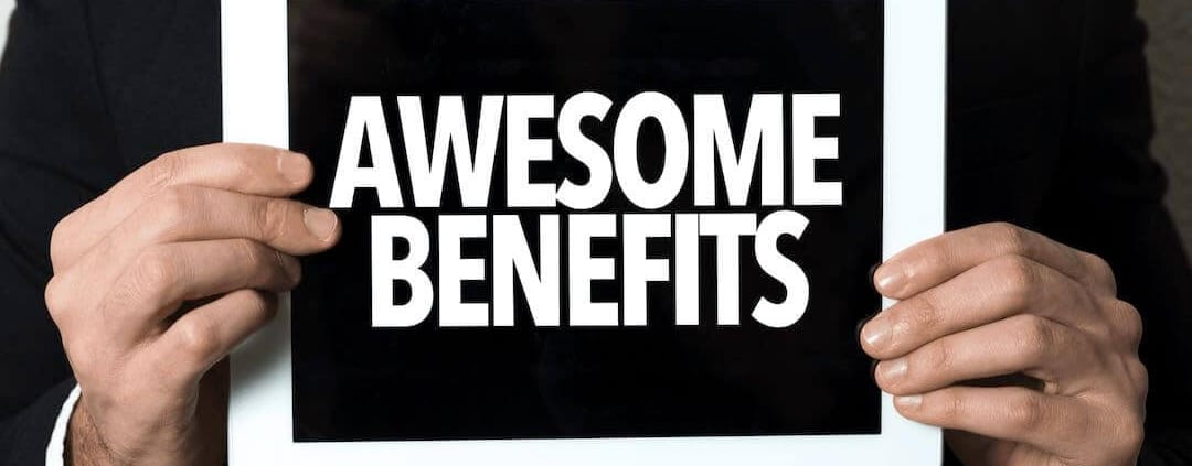 Mann hält ein Schild mit der Aufschrift "Awesome Benefits".