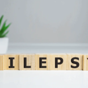 The-Real-CBD-Blog-can-CBD-help-in-treatgment-of-epilepsy-1 Epilepsy spelled out on wood blocks with CBD oil on the side