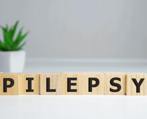Epilepsie gespeld op houten blokken met CBD-olie aan de zijkant