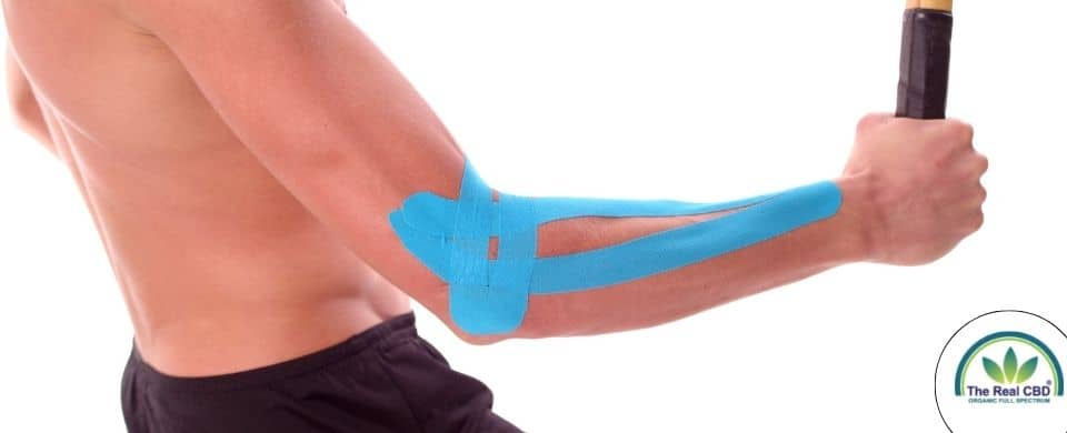Man holding a racket with kinesiology tape on his elbow
