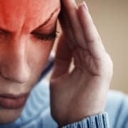 The-Real-CBD-Blog-CBD-for-headaches-to-arthritis-pain Woman holding her head in pain