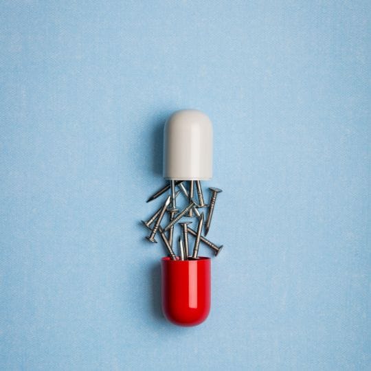 A split capsule with nails falling out