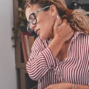 The-Real-CBD-Blog-Can-CBD-help-nerve-pain Woman holding her neck in pain