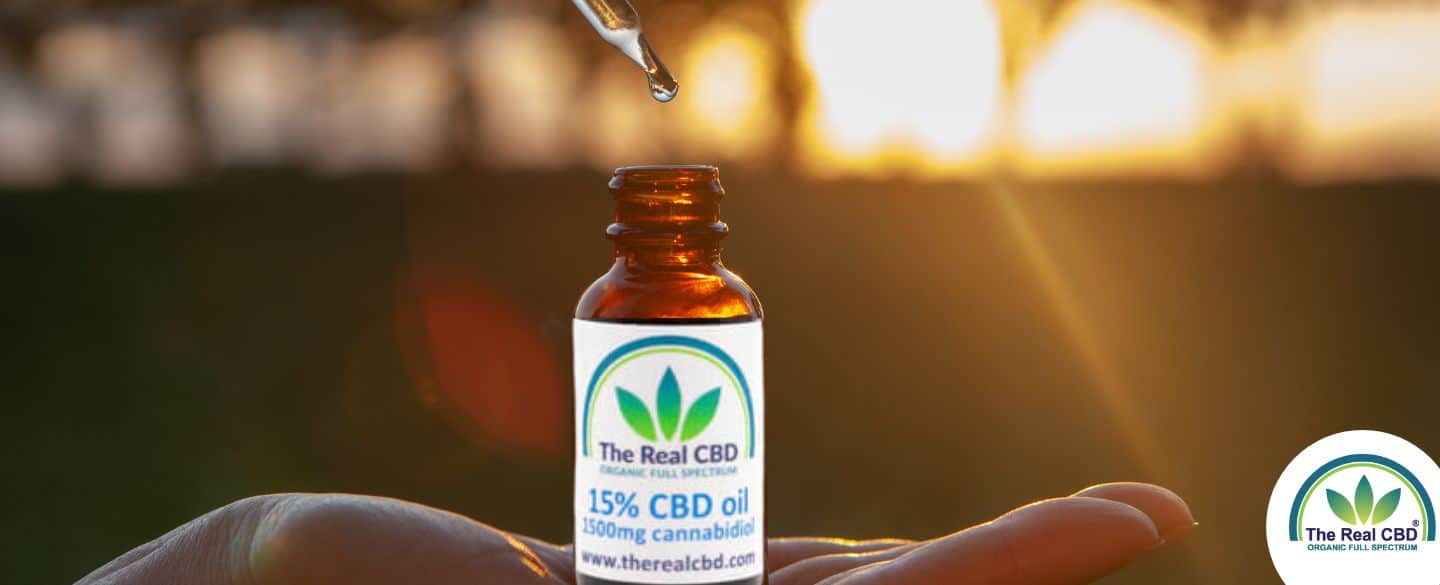 The Real CBD tincture bottle on a flat hand