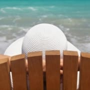 The Real CBD Blog CBD Tolerance Woman sitting in beach chair by the sea relaxing