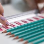 Der Real CBD Blog CBD für OCD Bleistifte und Büroklammern, die in ordentlichen Reihen liegen, mit einem Lineal, das die Finger organisiert