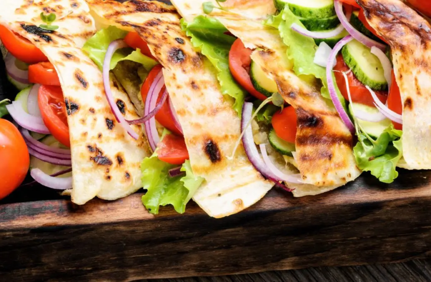 Pita bread sandwiches on a wooden tray