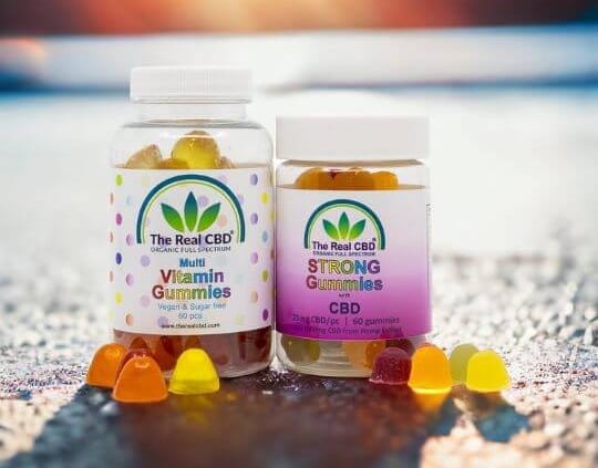 2 CBD gummi jars on cement surface - The Real CBD Brand
