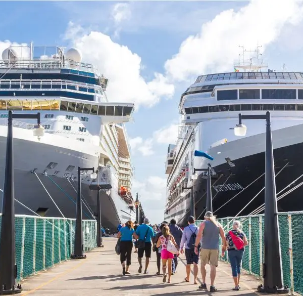 Two big cruise liners with tourist walking towards it