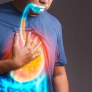 The-Real-CBD-blog-benefits-of-CBD-for-GERD Man feeling nauseous holding his chest