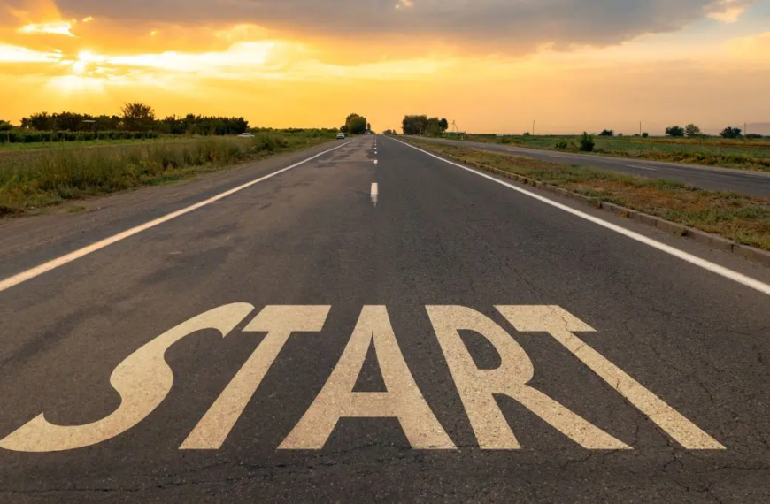 Tarmac road in sunrise with the word START