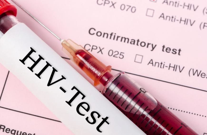 HIV blood test on a table with a syringe