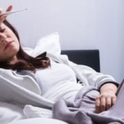 The-Real-CBD-Blog-CBD-for-fever Woman in bed with a high fever