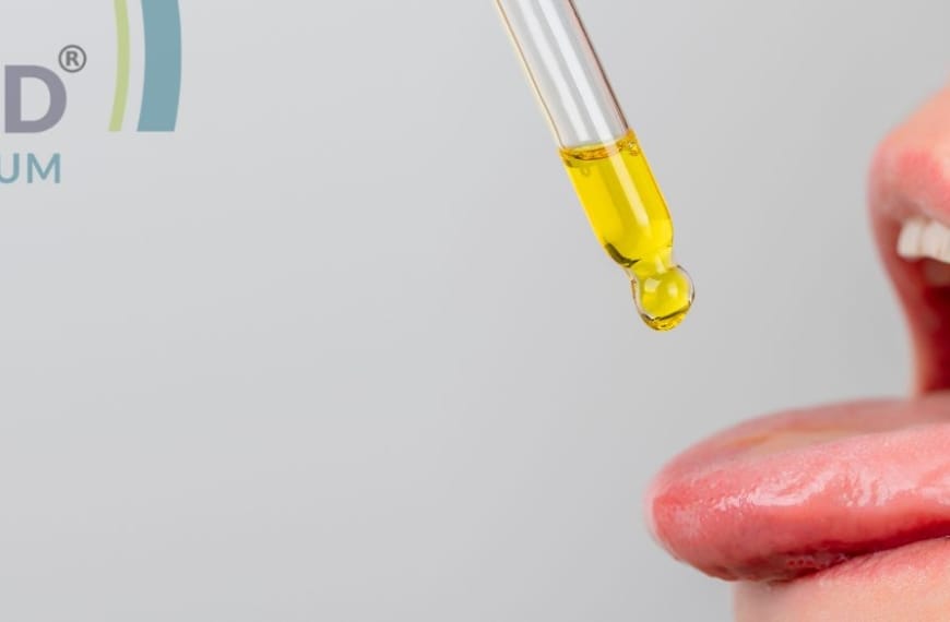 Personne tirant la langue et laissant tomber de l'huile de CBD dans sa bouche
