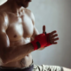 Mann wickelt seine Hand zum MMA-Kampf