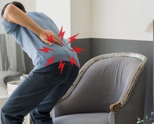Man bending over with back pain sciatica