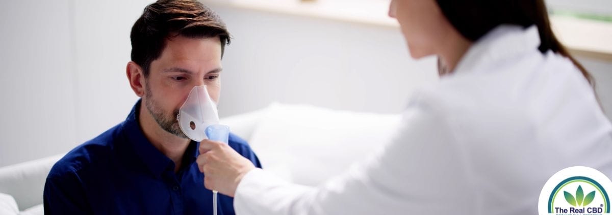 Man breathing in a oxygen mask held by a doctor
