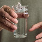 Händeschütteln mit einem Schluck Wasser