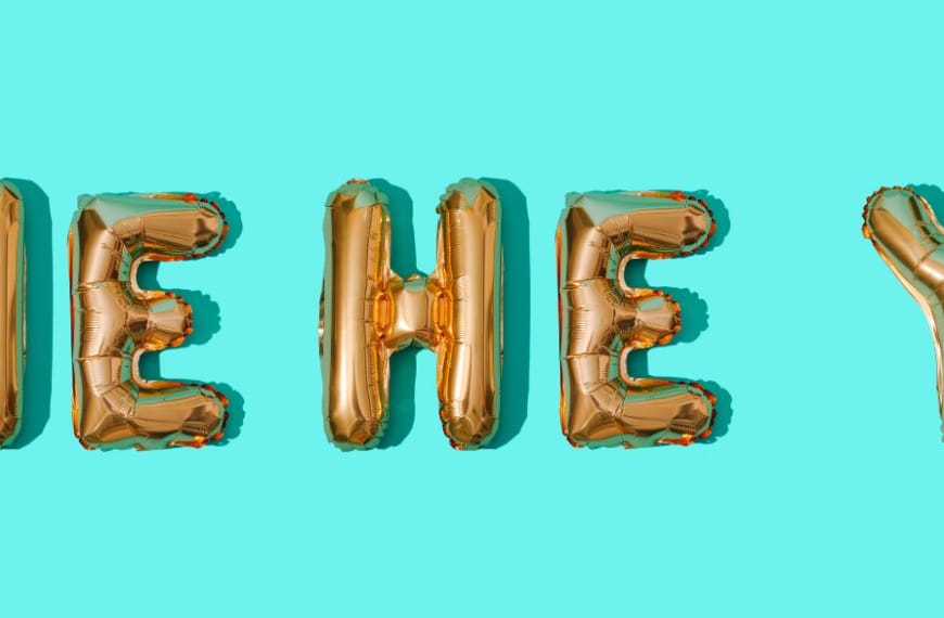 HE HE Y spelled in gold balloons