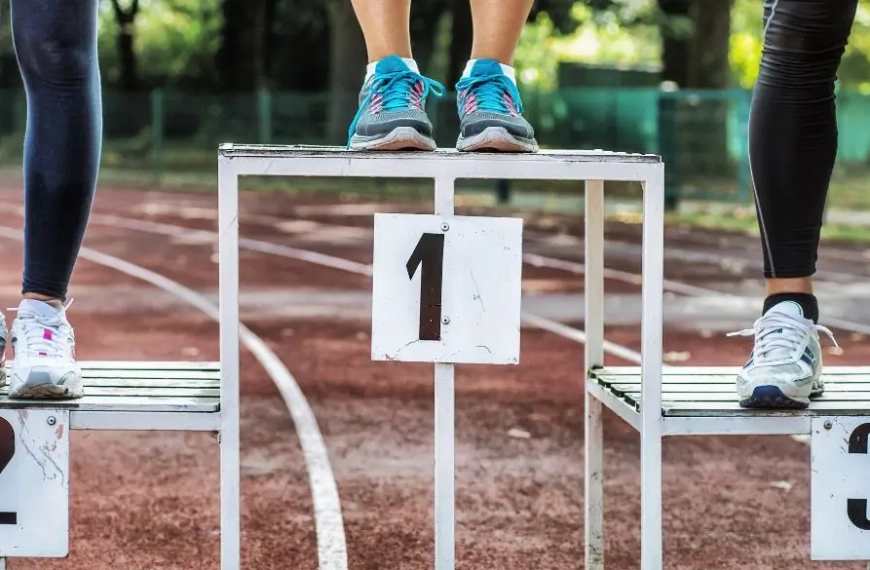Competition podium 1 2 3 with only athletes feet visible