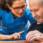 The-Real-CBD-blog-CBD-for-memory-support-in-seniors Woman helping an older man with a memory game
