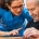 Woman helping an older man with a memory game