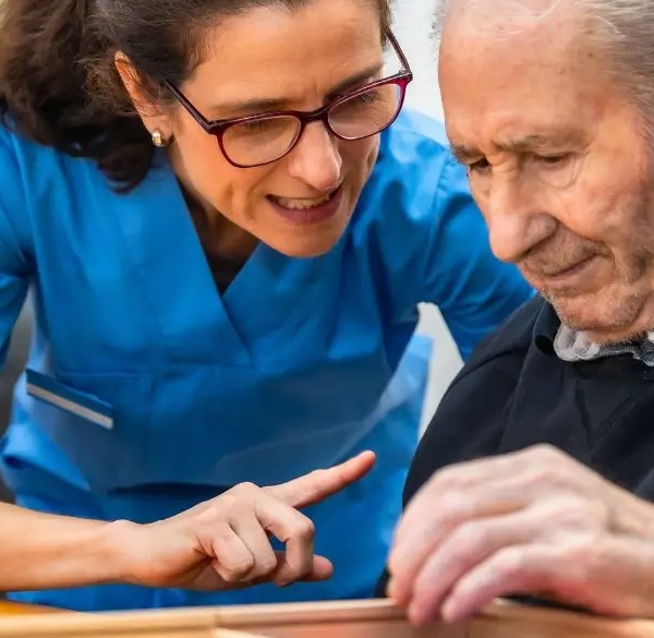 Woman helping an older man with a memory game