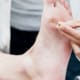 Doctor testing nerve reaction under a patients foot
