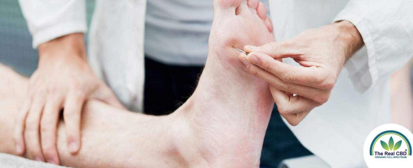Doctor testing nerve reaction under a patients foot