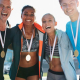 Athletes with medals around their necks cheering