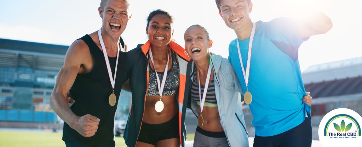 Athletes with medals around their necks cheering