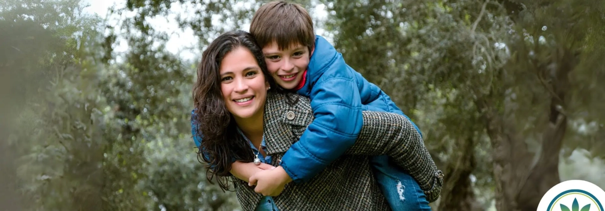 Sarah and her son looking happy in the woods