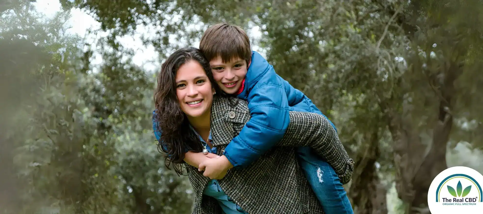 Sarah and her son looking happy in the woods