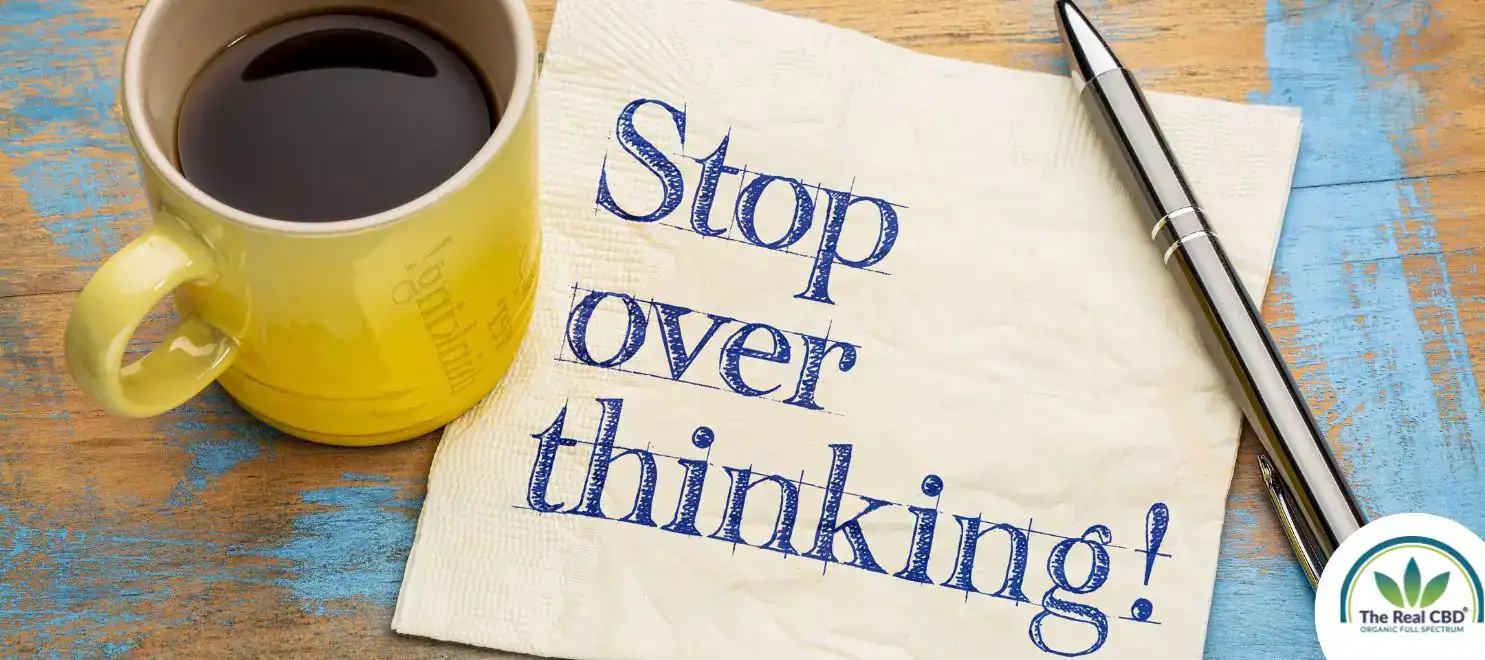 Coffee cup on a pc of paper saying OVERSTHINKING
