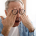 Older man rubbing his eyes