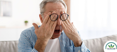 Older man rubbing his eyes