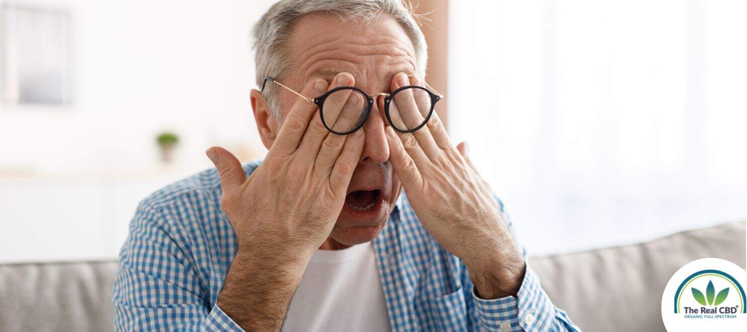 Older man rubbing his eyes