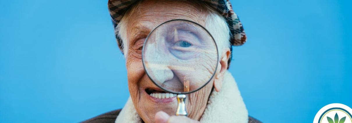 Older man holding a magnifying glass