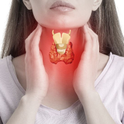 Woman holding her thyroid which seems inflammed