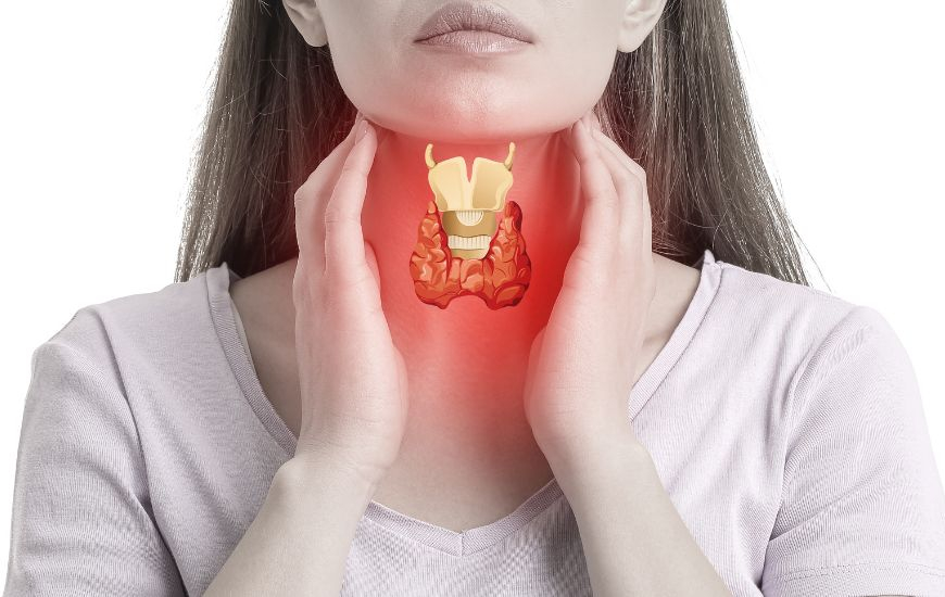 Woman holding her thyroid which seems inflammed