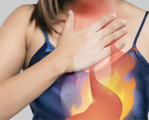 Woman holding her chest in pain showing heartburn