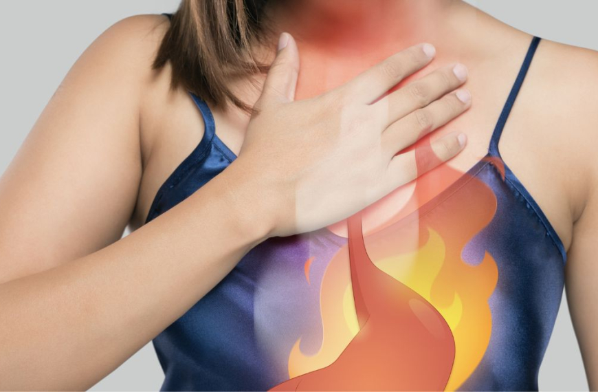 Woman holding her chest in pain showing heartburn